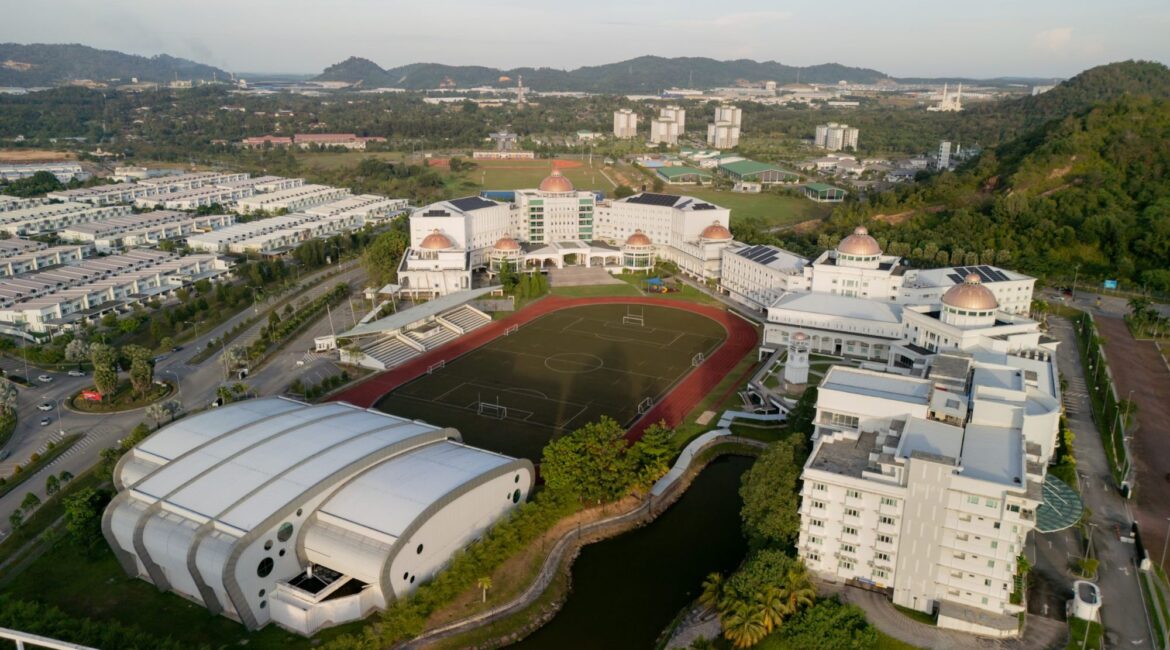 ドーム屋根の校舎とグラウンドが並ぶAdcote Matrix International Schoolのキャンパス全景